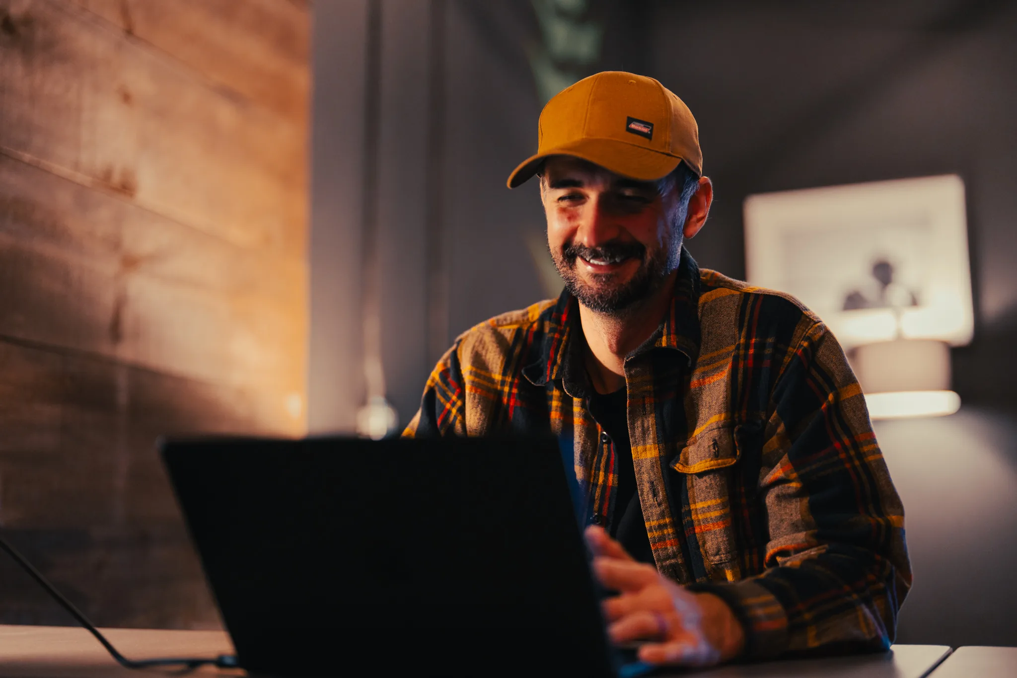 Tony, founder of ChasTech, smiling while working on a laptop